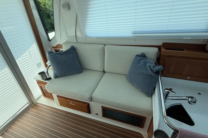 Slide: The Image of Interior of 2024 Back Cove 372 yacht with cozy seating and cushions. - 55
