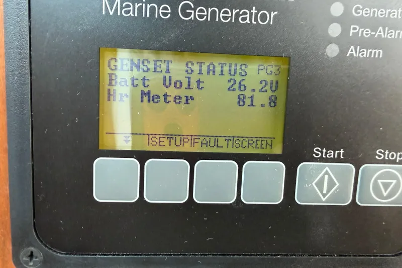 Slide: The Image of Marine generator display showing battery voltage and hour meter on Back Cove 372, 2024 model. - 38