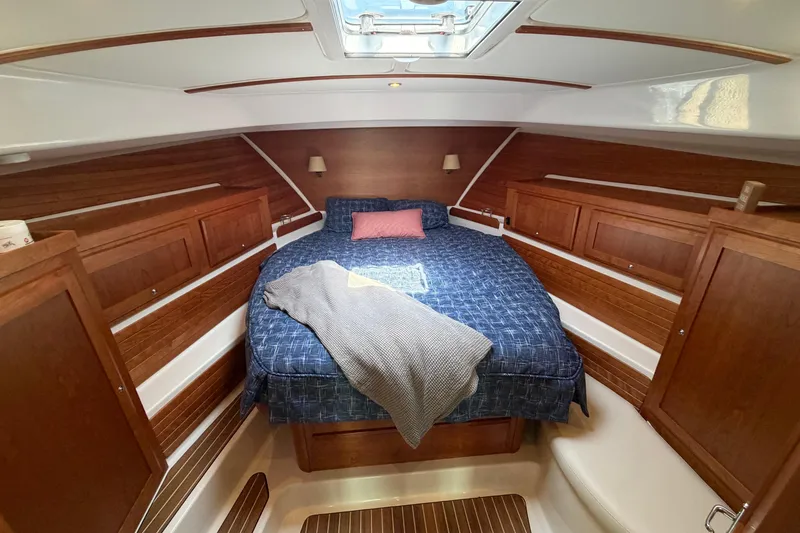 Slide: The Image of Luxurious cabin interior of 2024 Back Cove 372 yacht with cozy bed and wooden accents. - 31