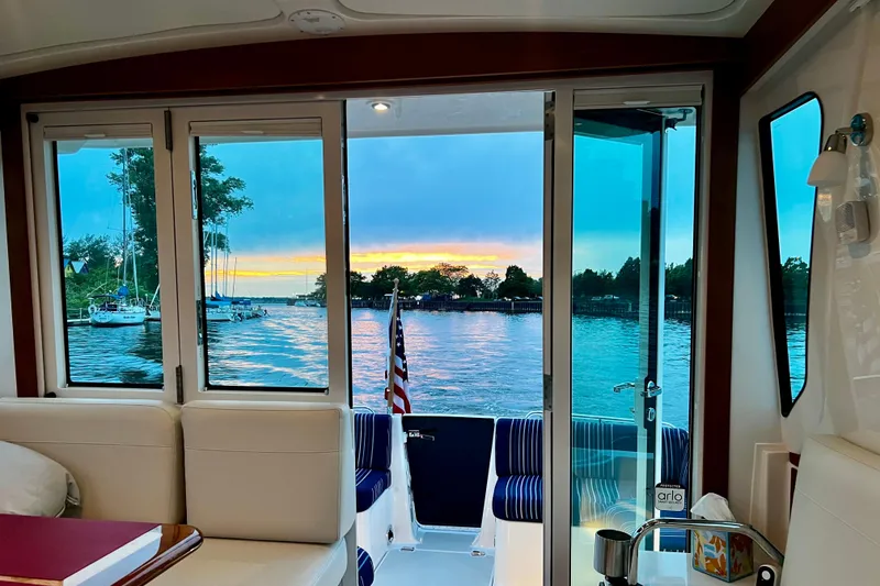 Slide: The Image of Interior view of 2024 Back Cove 372 yacht with scenic sunset over water. - 6