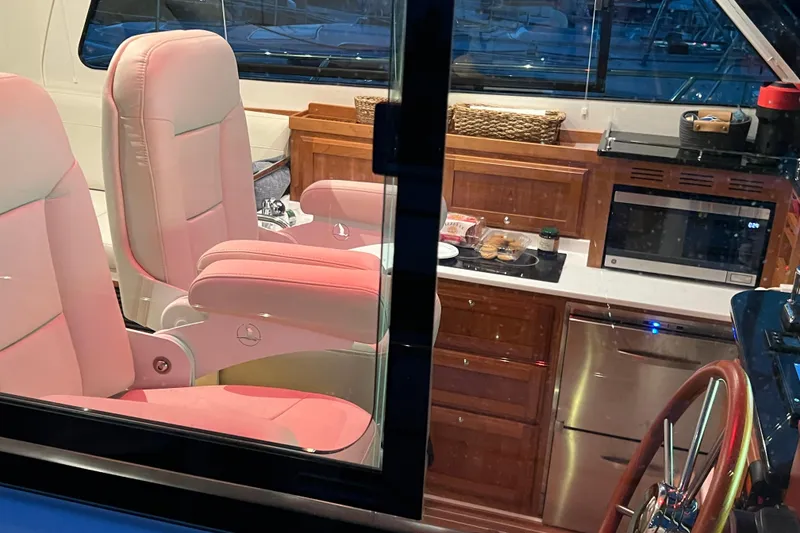 Slide: The Image of Luxurious interior of 2024 Back Cove 372 yacht with plush seating and modern kitchen amenities. - 17