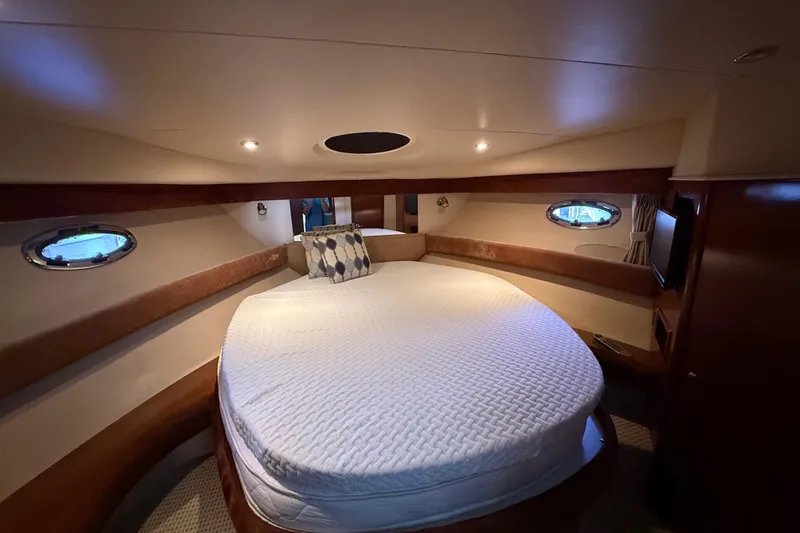 Slide: The Image of Luxurious cabin interior of a 2006 Meridian 341 Sedan yacht with cozy bedding. - 9