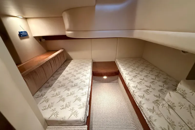 Slide: The Image of Cozy cabin interior of 2006 Meridian 341 Sedan with twin beds and soft lighting. - 11