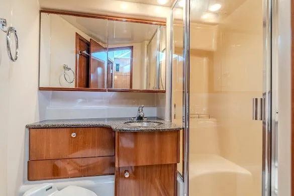 Slide: The Image of Luxurious bathroom in 2006 Meridian 341 Sedan yacht with wood cabinetry and modern fixtures. - 29
