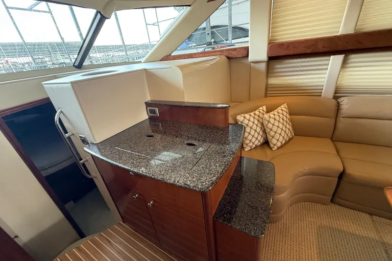 Slide: The Image of Interior of 2006 Meridian 341 Sedan yacht with granite countertops and beige seating. - 8