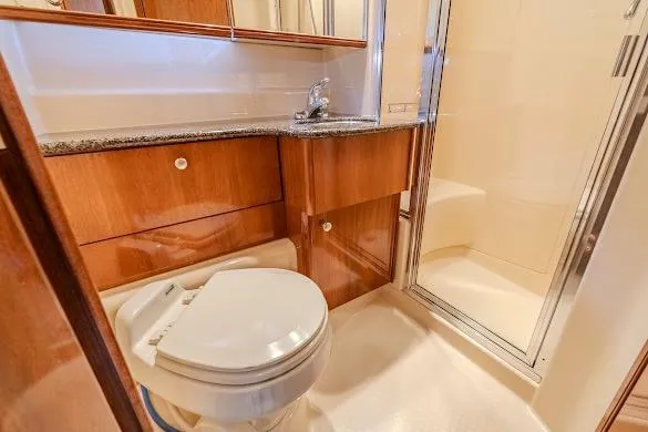 Slide: The Image of Luxurious bathroom in 2006 Meridian 341 Sedan yacht with wood cabinetry and shower. - 30