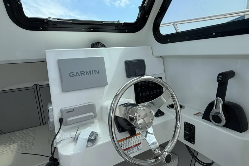 Slide: The Image of Interior view of 2027 Parker 227 Explorer boat cockpit with Garmin navigation system. - 16