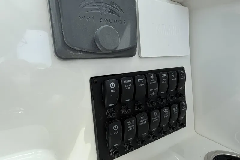 Slide: The Image of Control panel of a 2027 Parker 227 Explorer boat with labeled switches. - 17