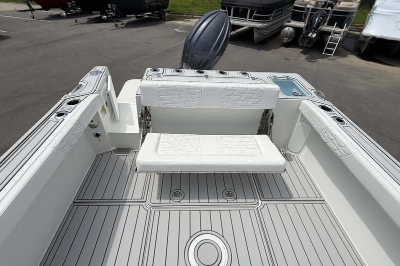 Slide: The Image of 2027 Parker 227 Explorer boat interior with white seating and deck, docked outdoors. - 8
