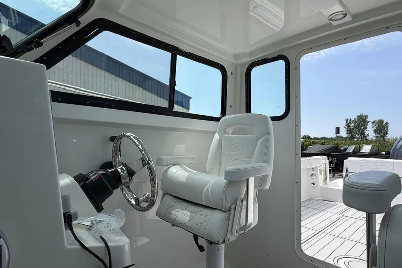 Slide: The Image of Interior of 2027 Parker 227 Explorer boat with steering wheel and captain's chair. - 15