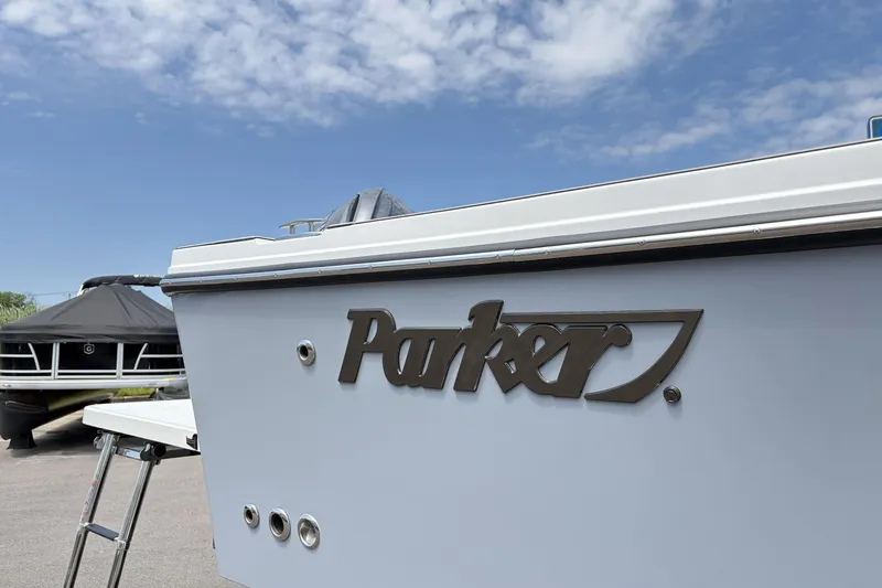Slide: The Image of Parker 227 Explorer boat, 2027 model, under a clear blue sky. - 23
