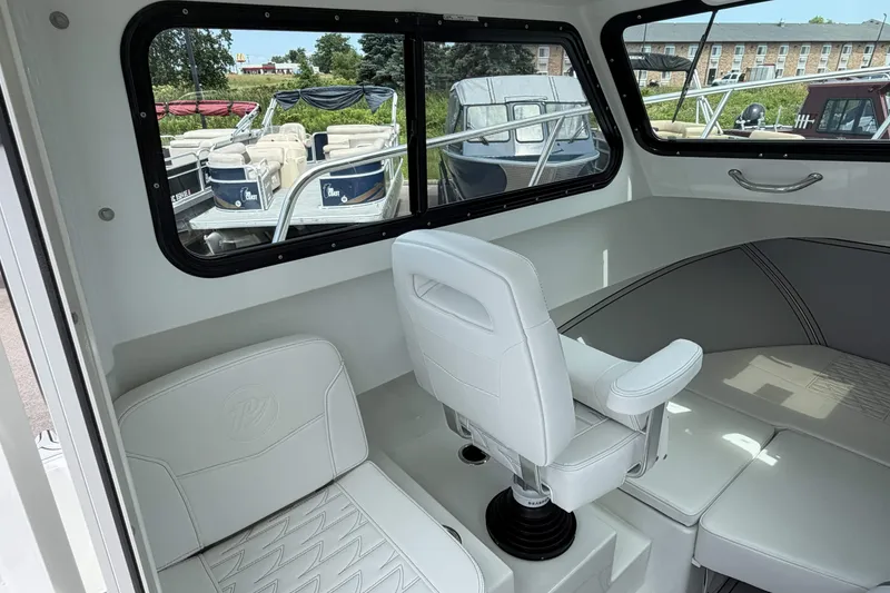 Slide: The Image of Interior of a 2027 Parker 227 Explorer boat with white seating and large windows. - 11