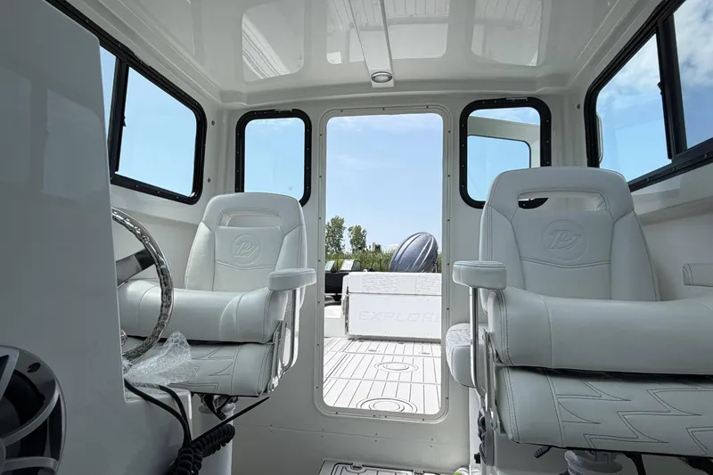 Slide: The Image of Interior of 2027 Parker 227 Explorer boat with white seating and steering wheel. - 20