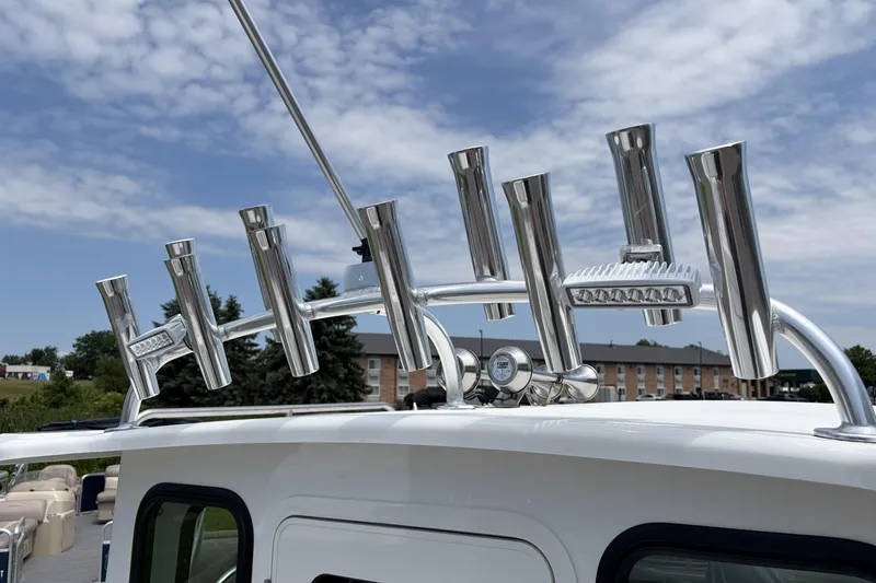 Slide: The Image of Stainless steel rod holders on 2027 Parker 227 Explorer boat under a partly cloudy sky. - 21