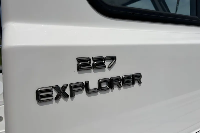 Slide: The Image of Close-up of 2027 Parker 227 Explorer boat model name on white surface. - 22