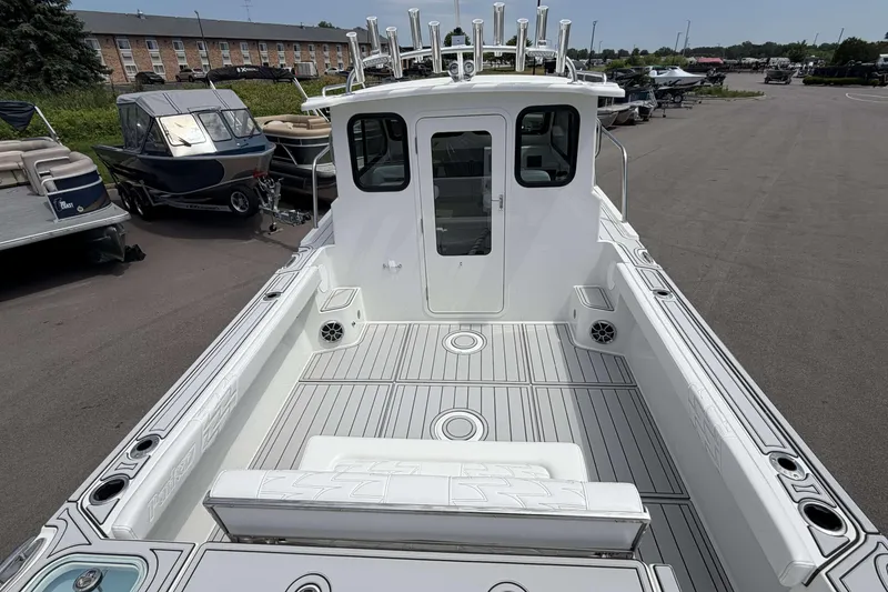 Slide: The Image of 2027 Parker 227 Explorer boat with spacious deck and modern design in a marina setting. - 4