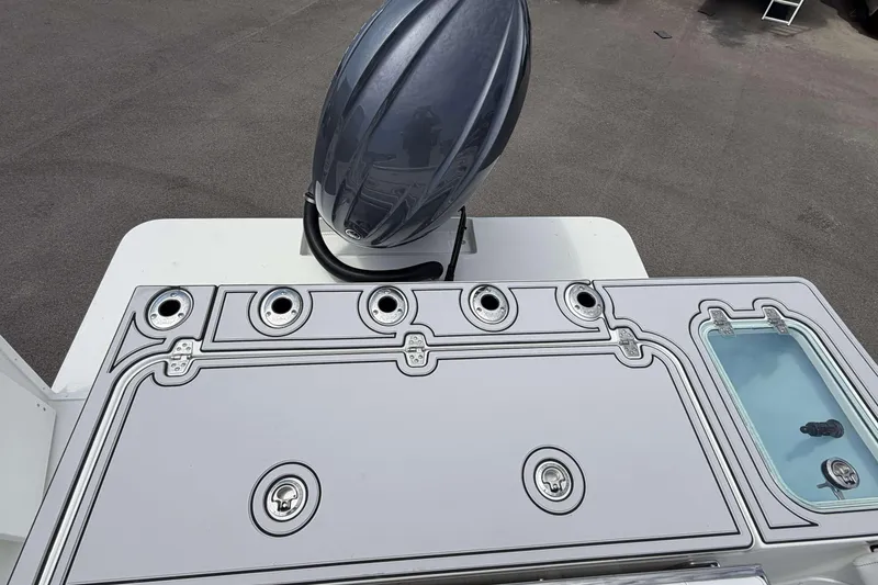 Slide: The Image of Parker 227 Explorer 2027 boat deck with storage compartments and motor cover. - 6