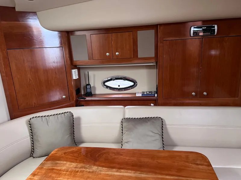 Slide: The Image of Interior of a 2004 Cruisers Yachts 400 Express with wood cabinetry and a small window. - 15