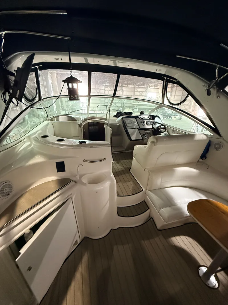 Slide: The Image of Interior of a 2004 Cruisers Yachts 400 Express with helm and seating area. - 9
