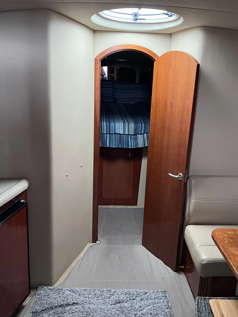Slide: The Image of Interior of a 2004 Cruisers Yachts 400 Express with cabin and seating area. - 19