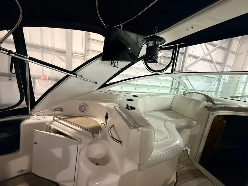 Slide: The Image of The image shows the cockpit of a 2004 Cruisers Yachts 400 Express. It features white upholstery and a modern design. - 12