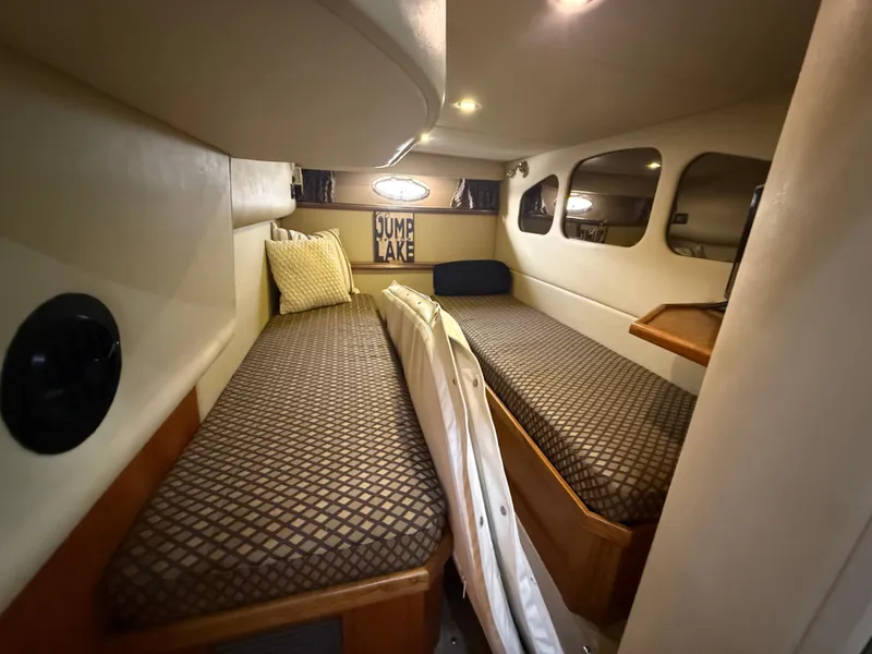 Slide: The Image of Interior of the 2004 Cruisers Yachts 400 Express with two single beds and cushions. - 22
