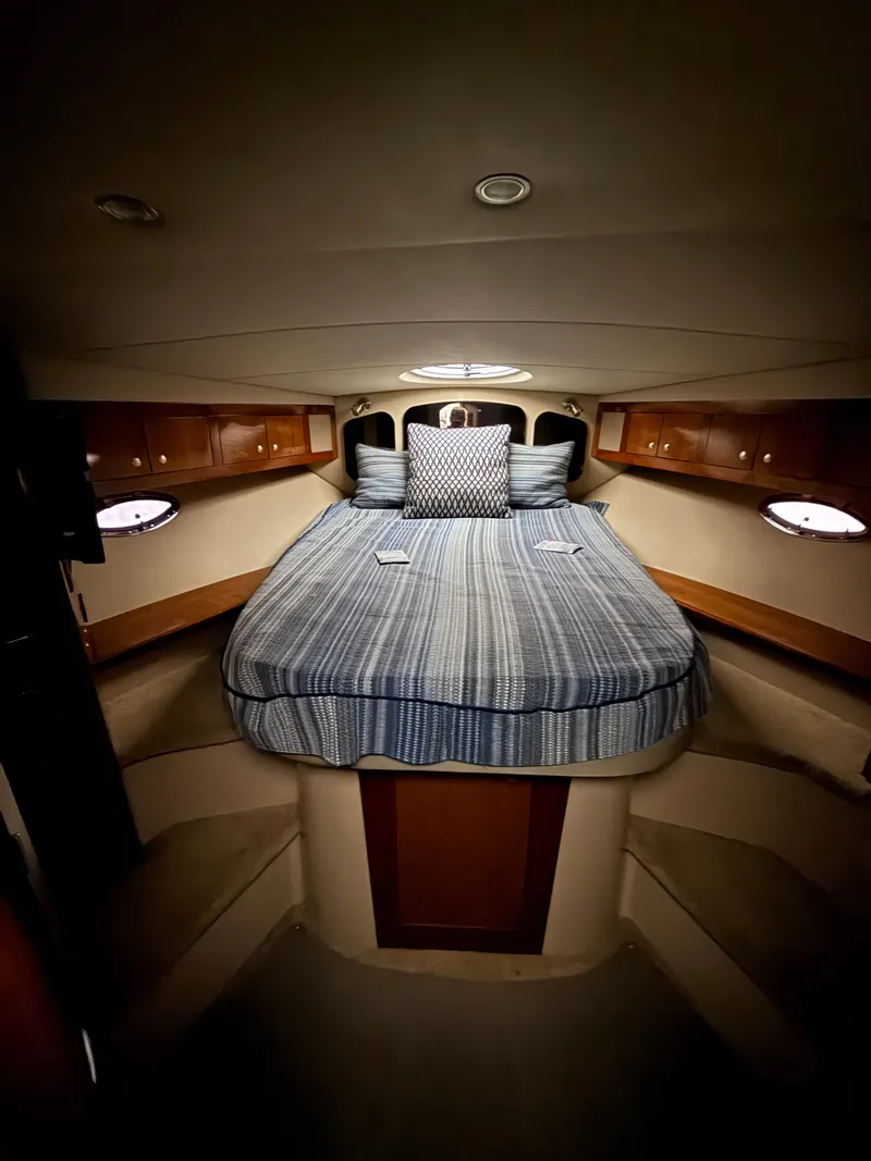 Slide: The Image of Cabin with a cozy bed and wooden cabinetry, surrounded by portholes. - 20