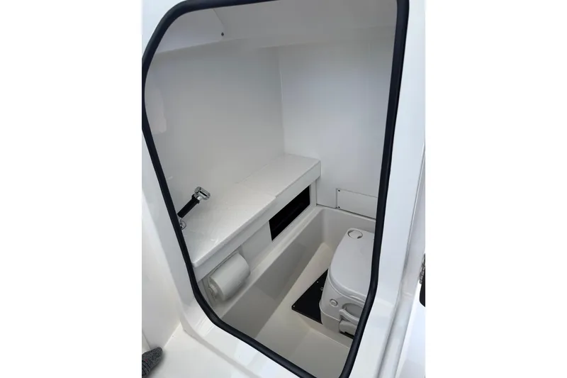 Slide: The Image of Interior of 2020 Blackfin 242 DC boat, featuring a compact marine toilet. - 33