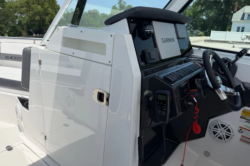 Slide: The Image of 2020 Blackfin 242 DC boat dashboard with Garmin navigation system and steering wheel. - 28