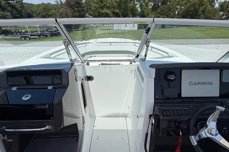 Slide: The Image of 2020 Blackfin 242 DC boat interior with Garmin navigation system and sleek dashboard design. - 26