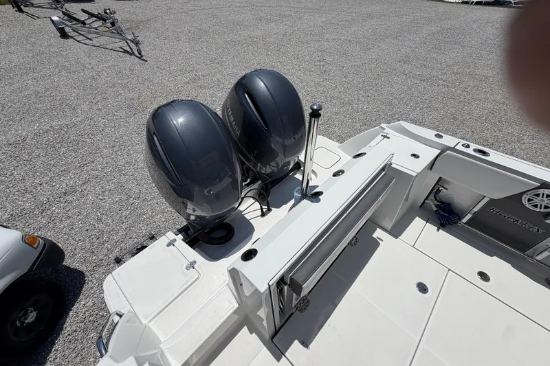 Slide: The Image of 2020 Blackfin 242 DC boat with dual Yamaha outboard engines on gravel surface. - 18