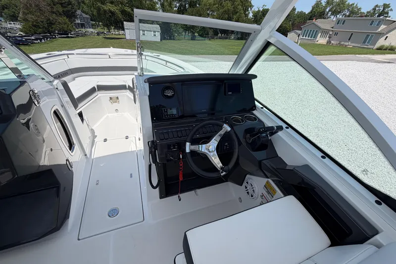 Slide: The Image of 2020 Blackfin 242 DC boat cockpit with modern steering and navigation controls. - 36