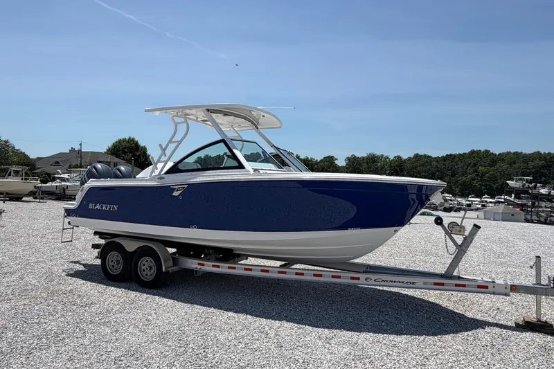 Slide: The Image of 2020 Blackfin 242 DC boat on trailer, parked outdoors on gravel. - 11