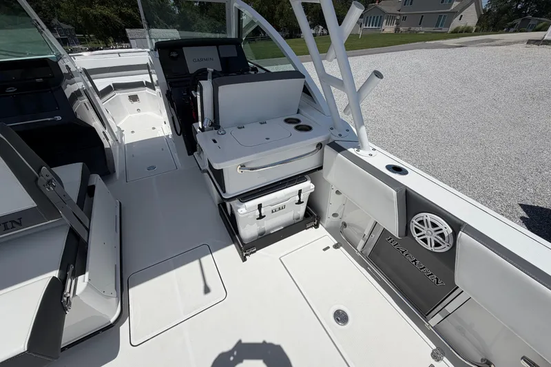 Slide: The Image of 2020 Blackfin 242 DC boat interior with seating, cooler, and Garmin navigation system. - 23