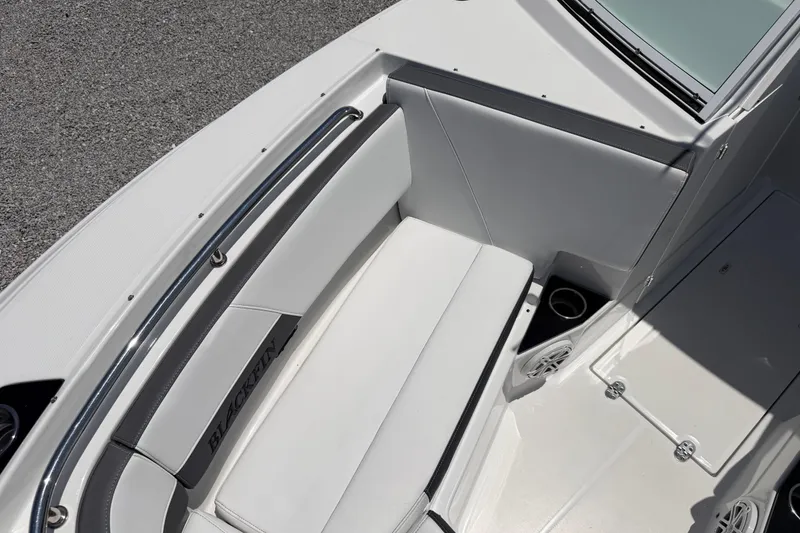 Slide: The Image of 2020 Blackfin 242 DC boat interior with white seating and cup holders. - 39