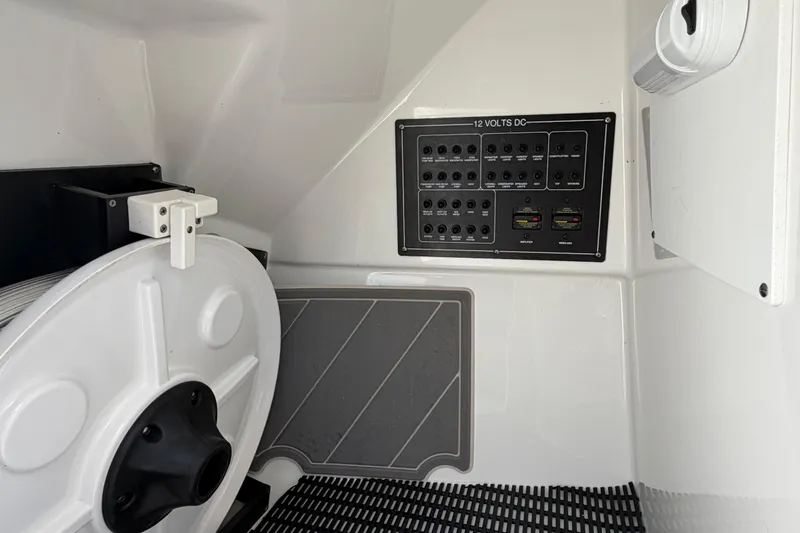 Slide: The Image of 2020 Blackfin 242 DC boat interior with 12V DC panel and equipment storage. - 27