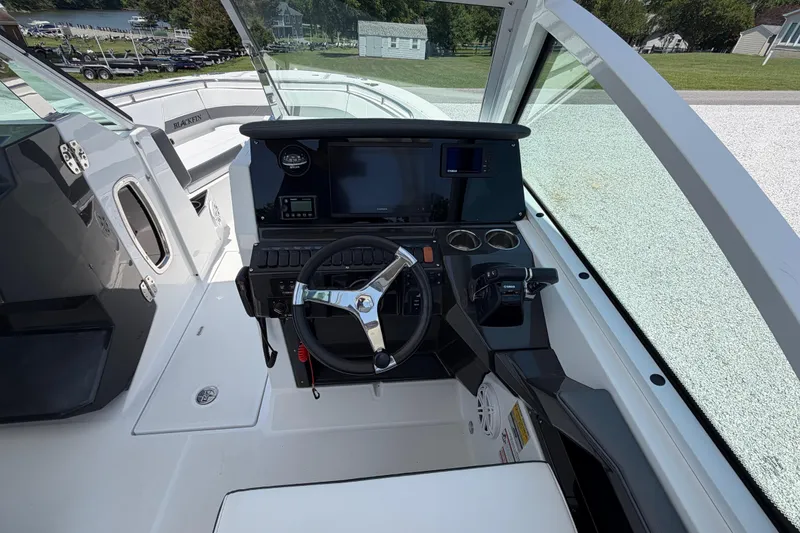 Slide: The Image of 2020 Blackfin 242 DC boat cockpit with steering wheel and control panel. - 35
