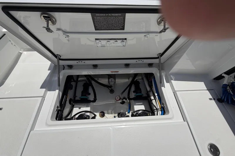 Slide: The Image of Open hatch of 2020 Blackfin 242 DC boat showing internal components and wiring. - 20