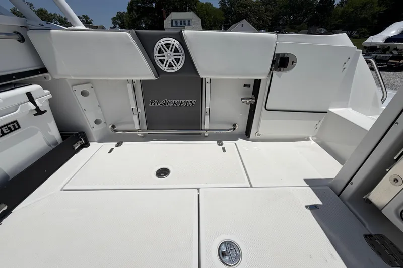 Slide: The Image of 2020 Blackfin 242 DC boat deck with Yeti cooler and storage compartments. - 22