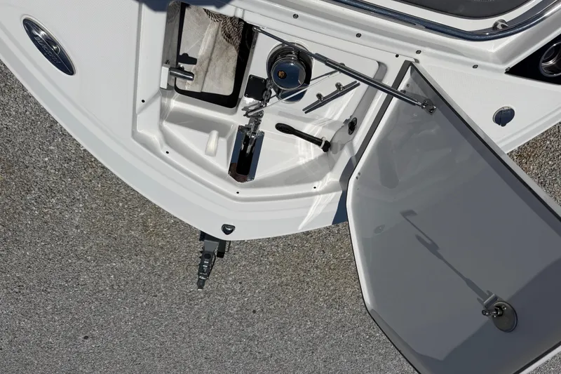Slide: The Image of 2020 Blackfin 242 DC boat anchor compartment with open hatch on a sunny day. - 43