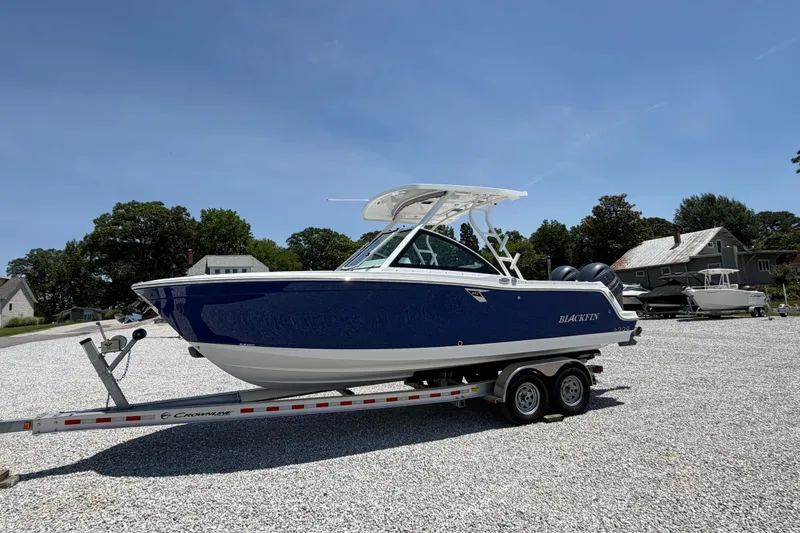 Slide: The Image of 2020 Blackfin 242 DC boat on trailer in sunny outdoor setting. - 3