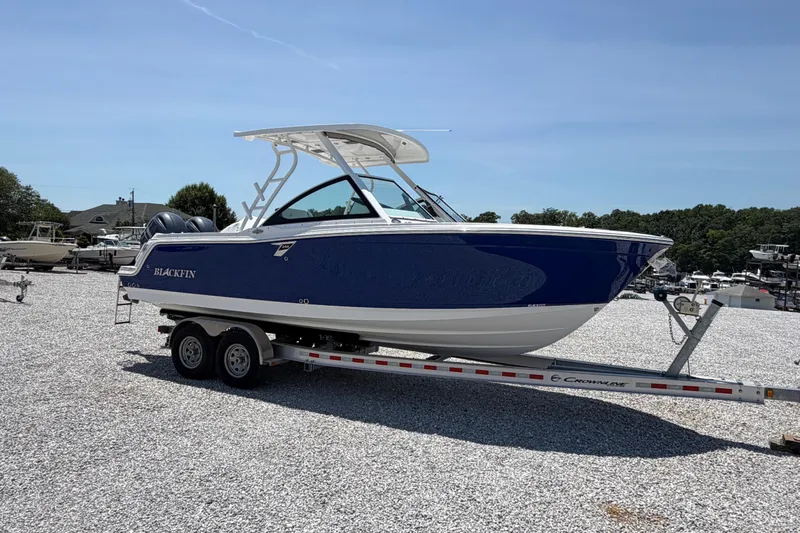 Slide: The Image of 2020 Blackfin 242 DC boat on trailer in sunny outdoor setting. - 13