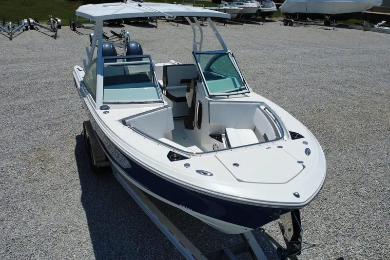 Slide: The Image of 2020 Blackfin 242 DC boat on trailer, displayed outdoors on gravel lot. - 4