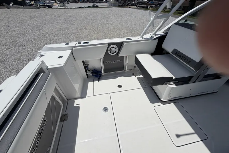 Slide: The Image of 2020 Blackfin 242 DC boat interior with seating and storage compartments. - 19