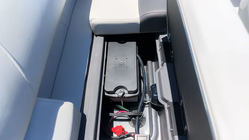 Slide: The Image of A battery compartment in a boat with an installed battery and wiring. - 9