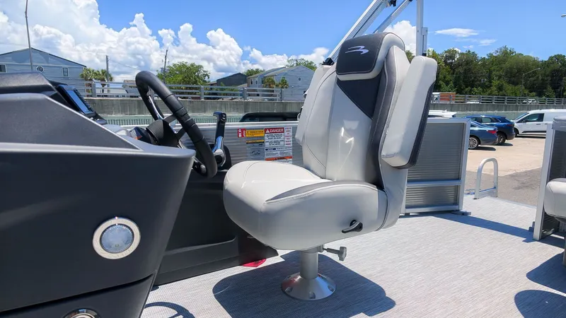 Slide: The Image of A modern boat seat with gray upholstery and black backrest on a Bennington 18 S CRUISE. - 19