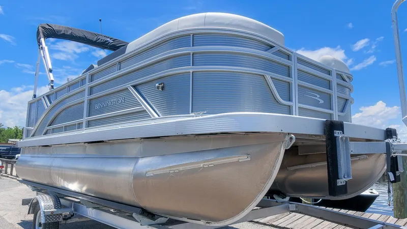 Slide: The Image of A modern Bennington 18 S CRUISE pontoon boat on a trailer, ready for use. - 3