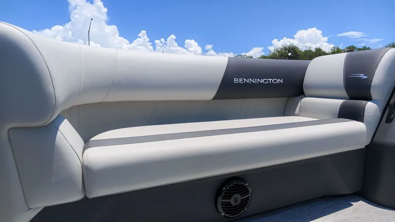 Slide: The Image of The Bennington 18 S CRUISE features a sleek, cushioned bench seat with a speaker below. - 15