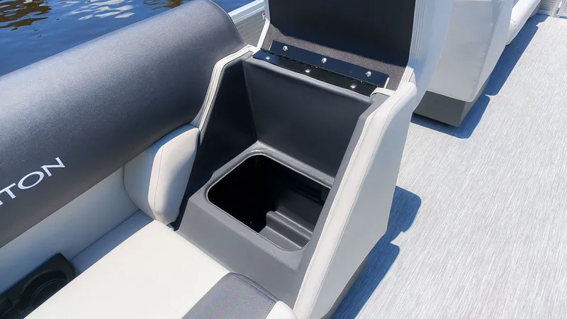 Slide: The Image of The 2027 Bennington 18 S CRUISE features an open storage compartment under a seat on a gray floor. - 10