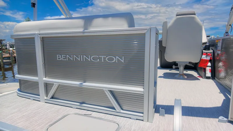 Slide: The Image of The image shows a Bennington 18 S CRUISE pontoon boat with gray seating and textured flooring. - 4
